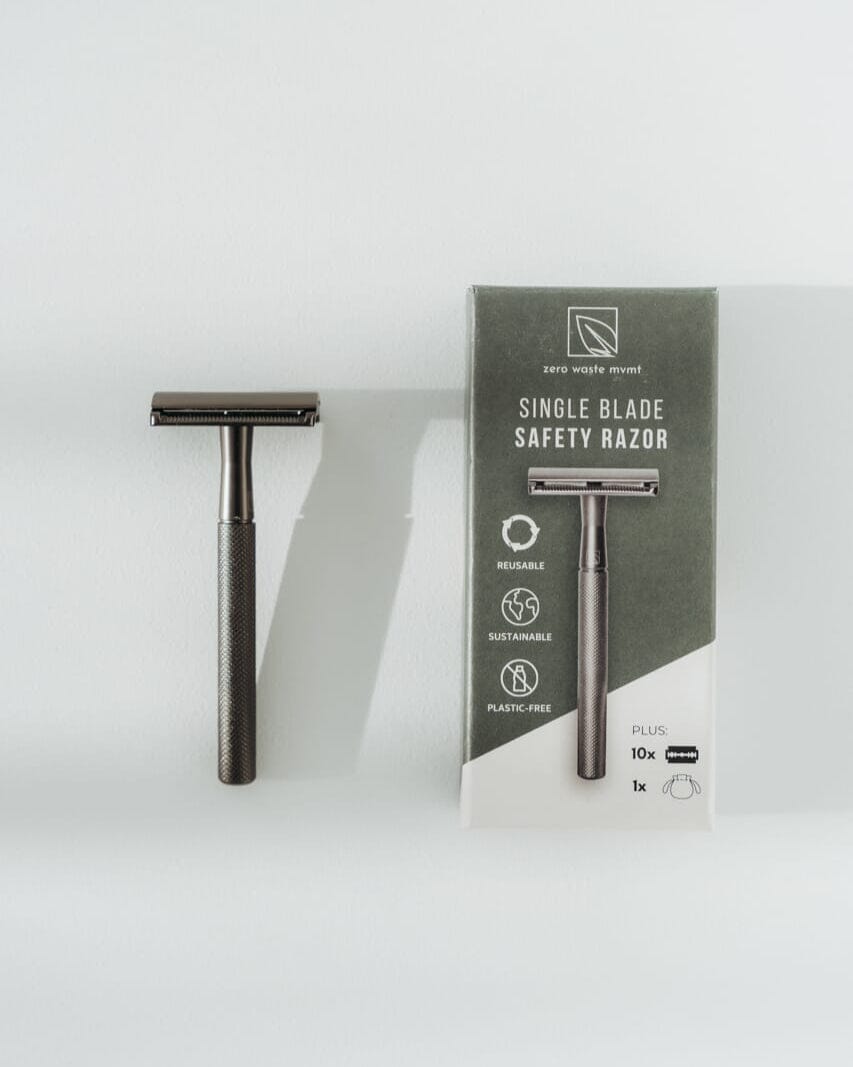 Single blade safety razor with packaging on a white background