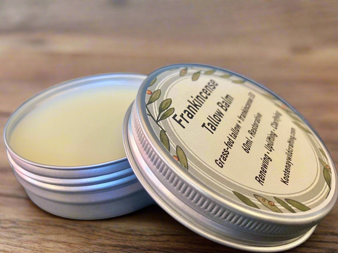 Tallow balm in a metal tin with a label on a wooden surface