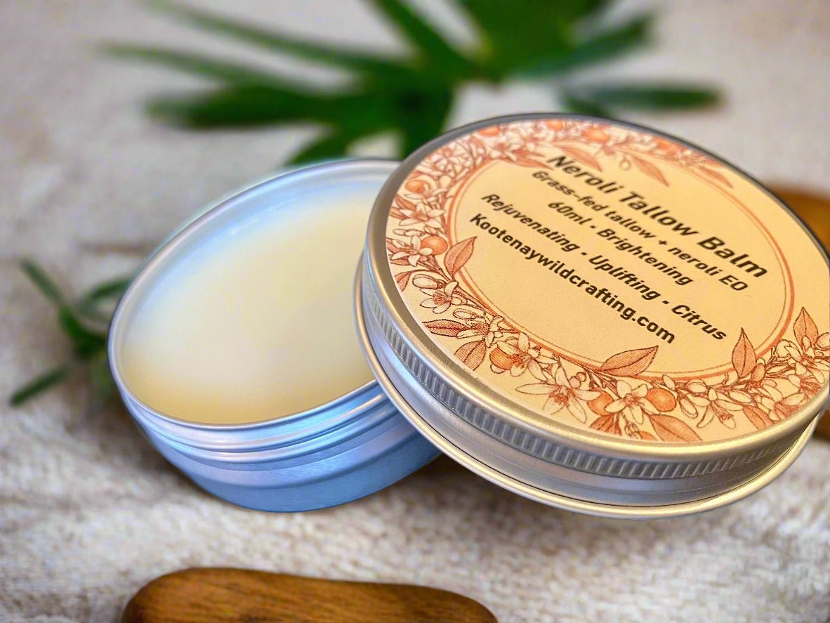 Naveli Tallow Balm tin with decorative label on a textured surface with green leaves.