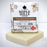 Bar of soap with Maple Hills Soapworks packaging on a white background