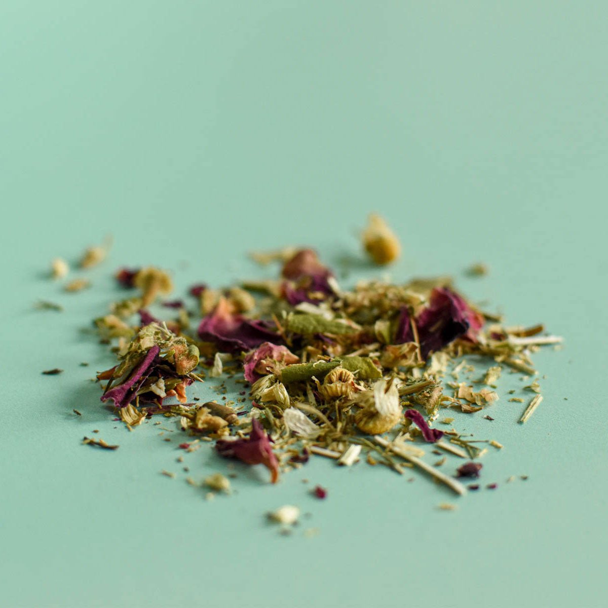 Heap of dried herbs on a light green background Rose & Chamomile Loose Herbal Tea | Floèm