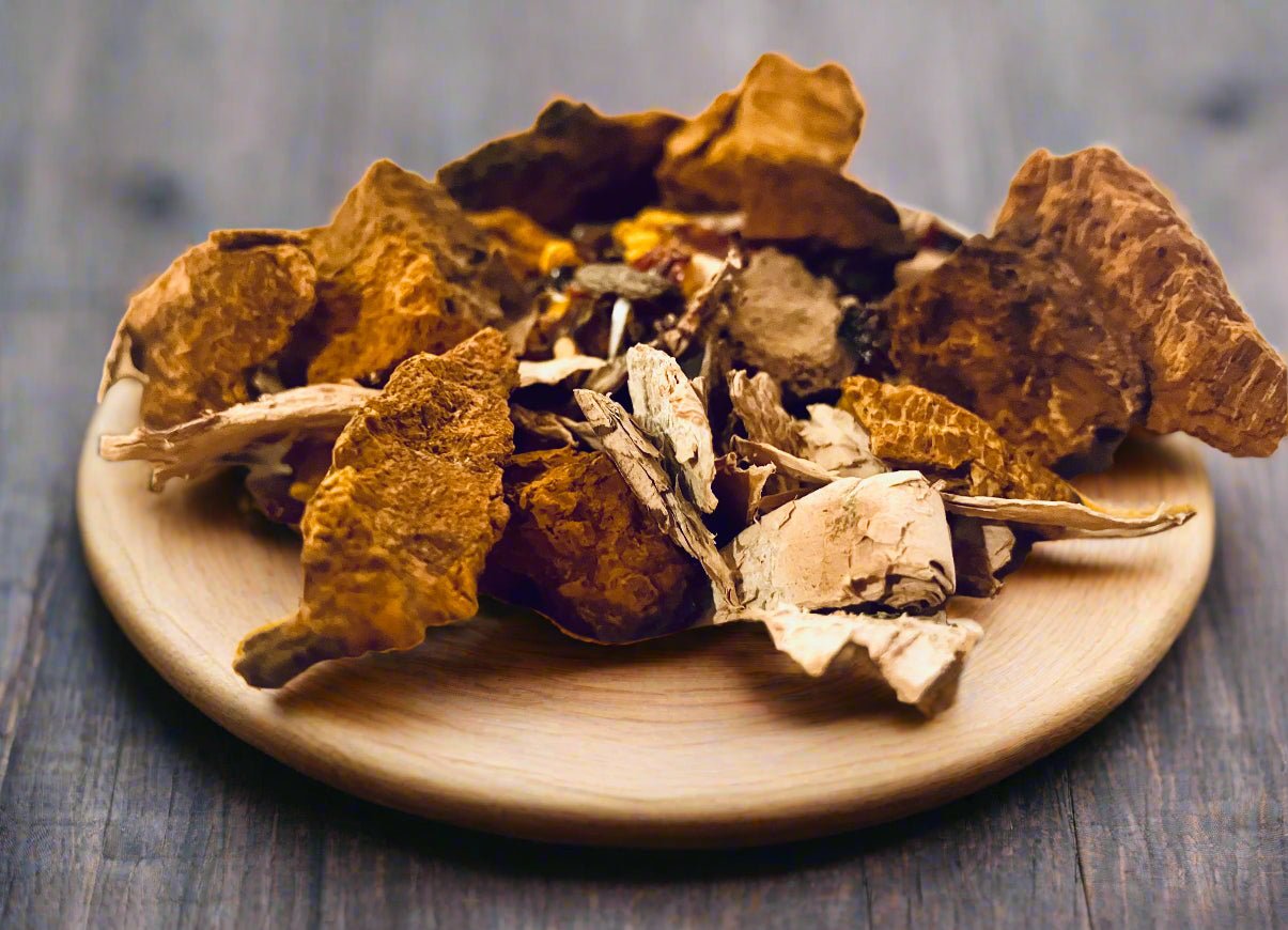 Dried herbs on a wooden plate with a blurred background