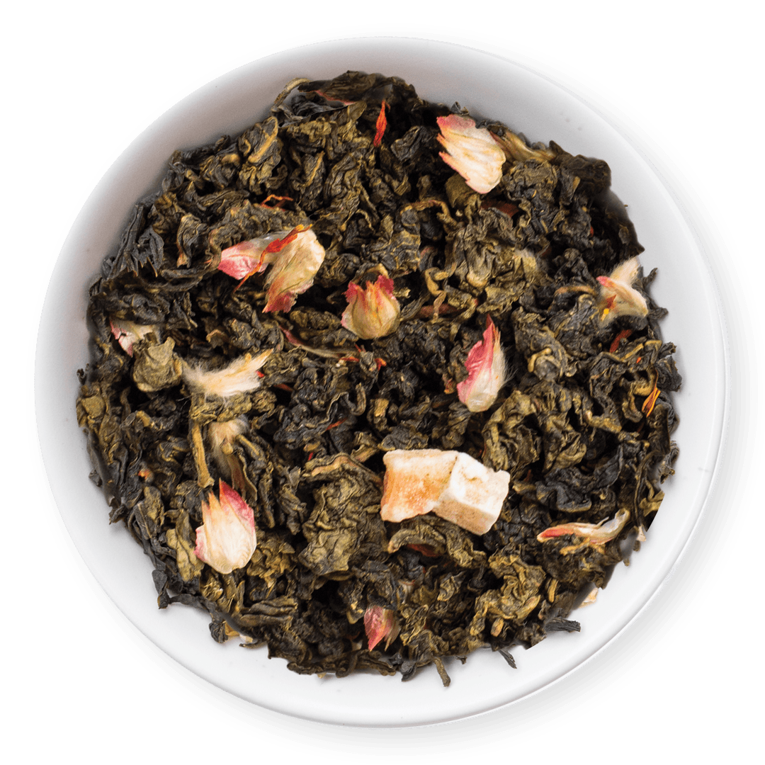 Tea leaves with floral elements in a white bowl on a dark background