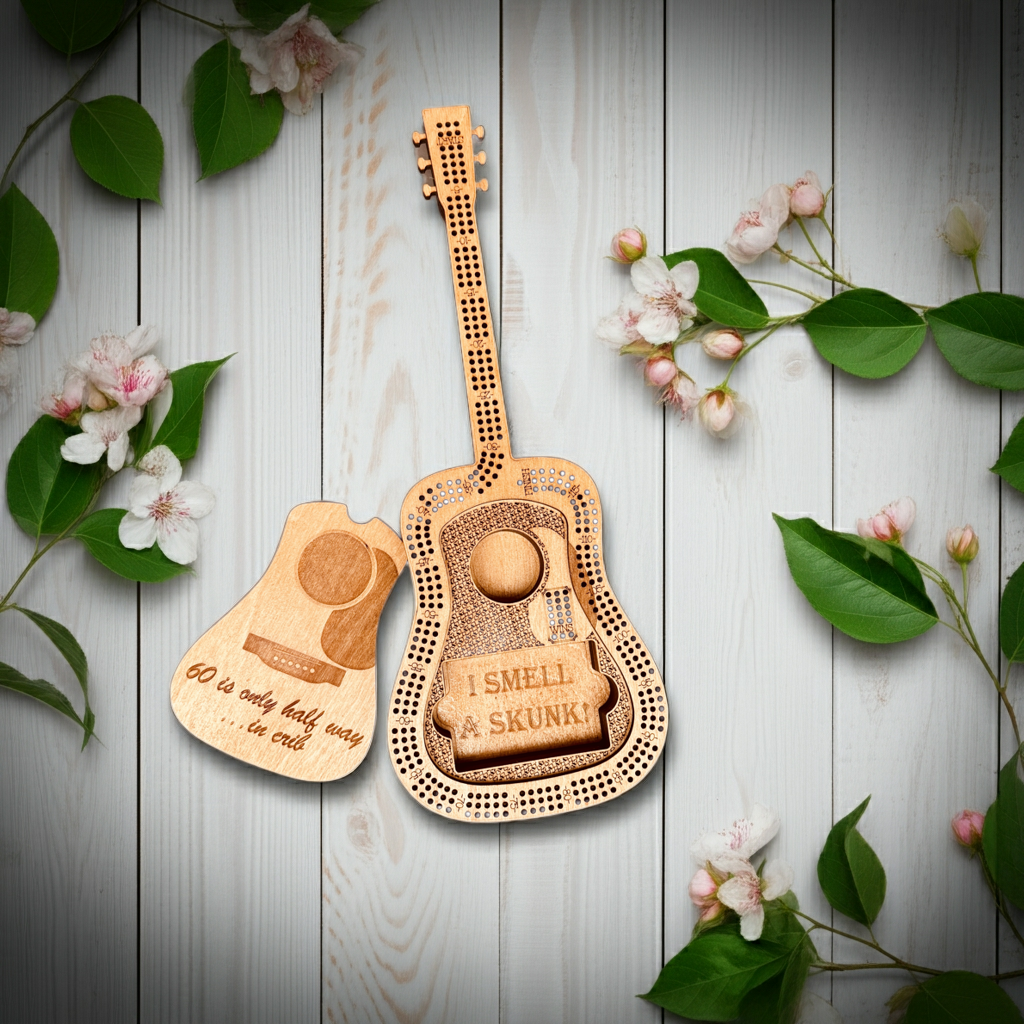 Creations by Alfie guitar-shaped cribbage board with removable cover on a floral background.